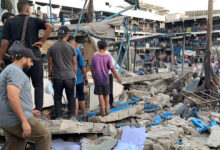 Un Staff And Palestinians Inspect The Site After Israeli Attack On A School Of The United Nations Relief And Works Agency